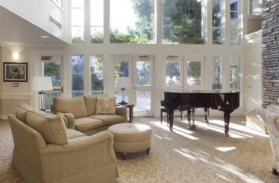 Bright living room with piano and seating area