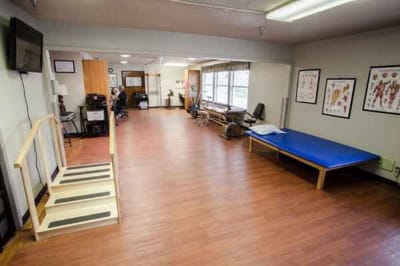 Interior view of a therapy room with equipment and seating