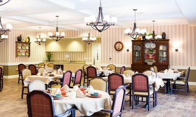 Bright dining room with tables set for meals