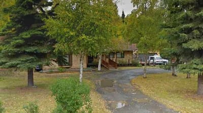Exterior view of an assisted living facility surrounded by trees