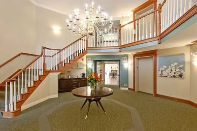 Interior view of a welcoming lobby with chandelier