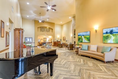 Bright and inviting lobby with a piano and seating