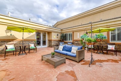 Outdoor seating area with comfortable furniture and umbrellas