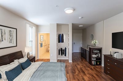 A cozy resident room with a bed and bathroom