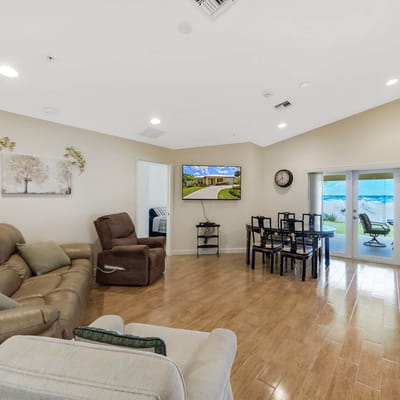 Bright common area with seating and a TV