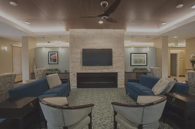 Cozy common area with seating and stone fireplace