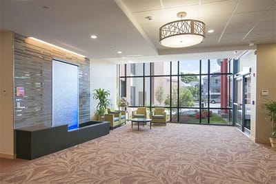 Bright lobby area with seating and water feature