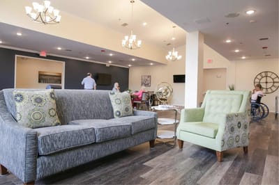 Bright interior common area with seating and residents