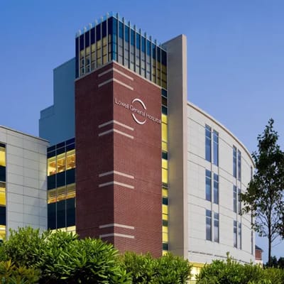 Exterior view of Lowell General Hospital building at dusk