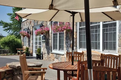 Outdoor seating area with tables and umbrellas