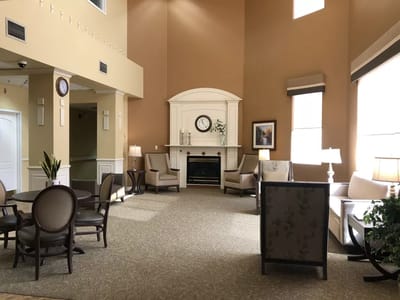Bright common area with seating and a fireplace