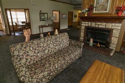 Cozy common area with fireplace and floral couch