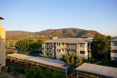 View of the facility exterior with mountains in the background