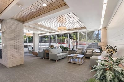 Bright common area with comfortable seating and large windows
