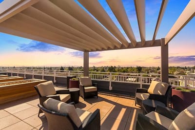 Outdoor terrace with seating area and sunset view