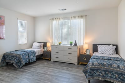 A shared resident room with twin beds and decor