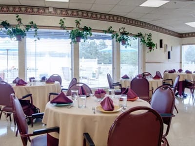 Dining area with tables set for residents
