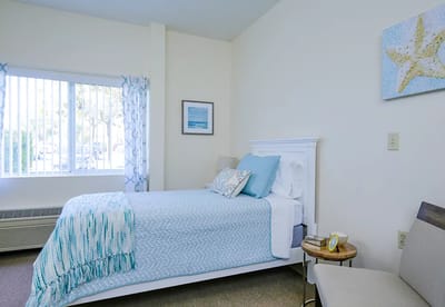 A cozy private resident room with a bed and decor