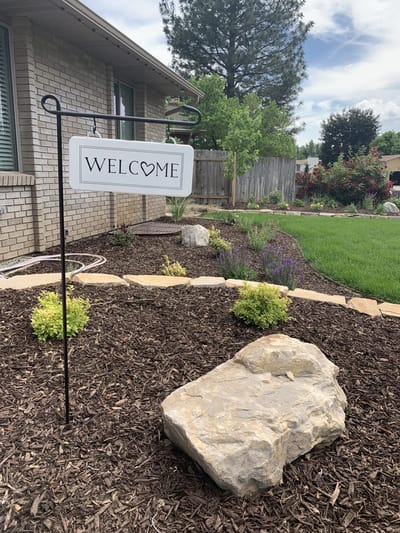 Welcome sign in a landscaped outdoor area