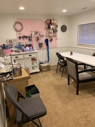 Crafting space with materials organized on shelves