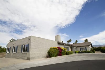 Exterior view of a senior care home with landscaping