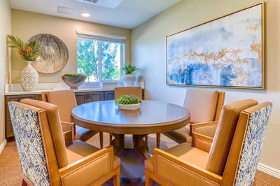 Bright common area with a circular table and chairs