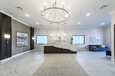 Modern lobby area with chandelier and reception desk
