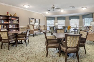 Bright common area with comfortable seating and bookshelves