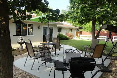 Outdoor seating area with trees and garden features