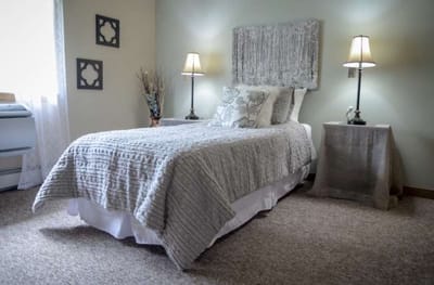 Cozy resident room with a bed and lamps