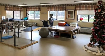 Physical therapy room with equipment and a Christmas tree