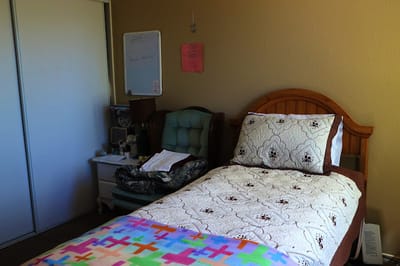 Cozy resident room with a bed and chair