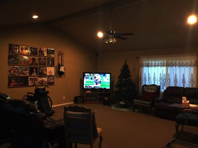 A cozy common area with seating and a TV.