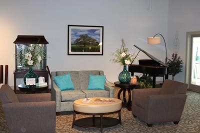 Common area with seating and decor in a senior living facility