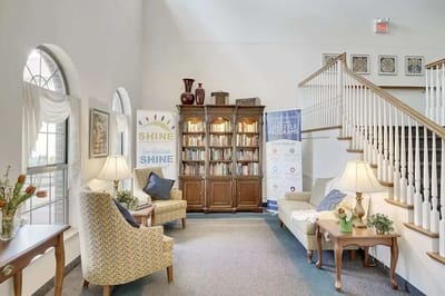 Bright common area with seating and shelves