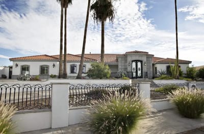 Exterior view of a senior living facility with palm trees