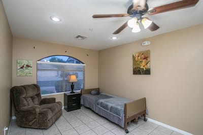 Cozy resident bedroom with chair and lamp