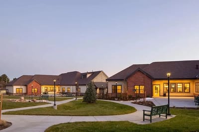 Exterior view of Beatrice Hover Assisted Living Residence at dusk