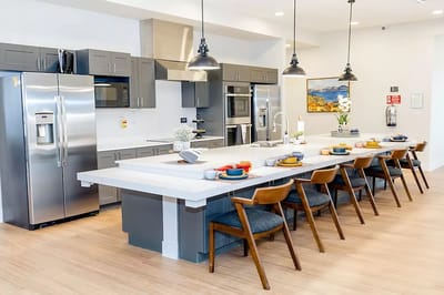 Modern kitchen area with seating and appliances