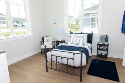 Well-furnished senior living bedroom with natural light