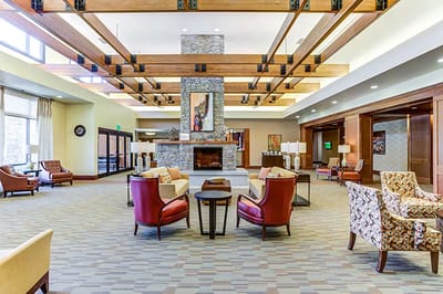 Spacious common area with comfortable seating and a fireplace