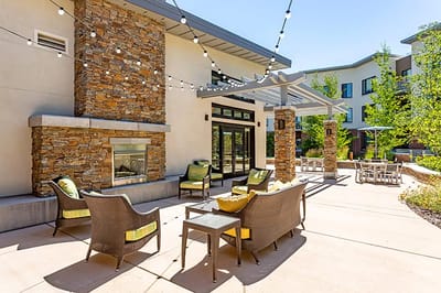 Outdoor seating area with string lights and stone accents