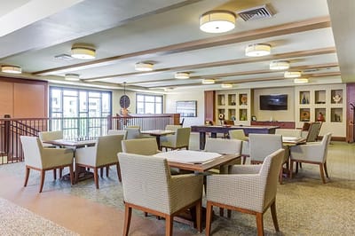 Bright common area with tables and chairs in interior space