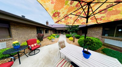 Outdoor seating area with colorful umbrella and plants