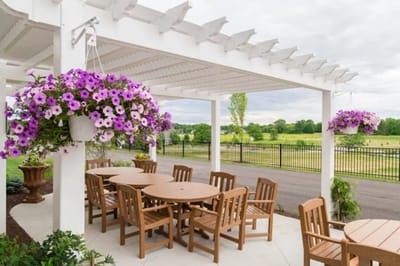 Outdoor seating area with flowers and tables