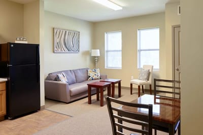 Bright and cozy living room area in a resident room