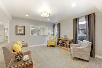 Bright common area with cozy seating and decor