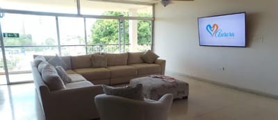 Bright common area with seating and large windows