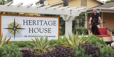 Resident greeting outside at the Heritage House sign