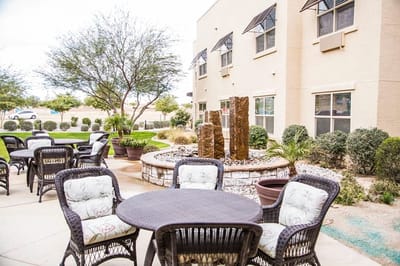 Outdoor seating area with fountain and landscaping